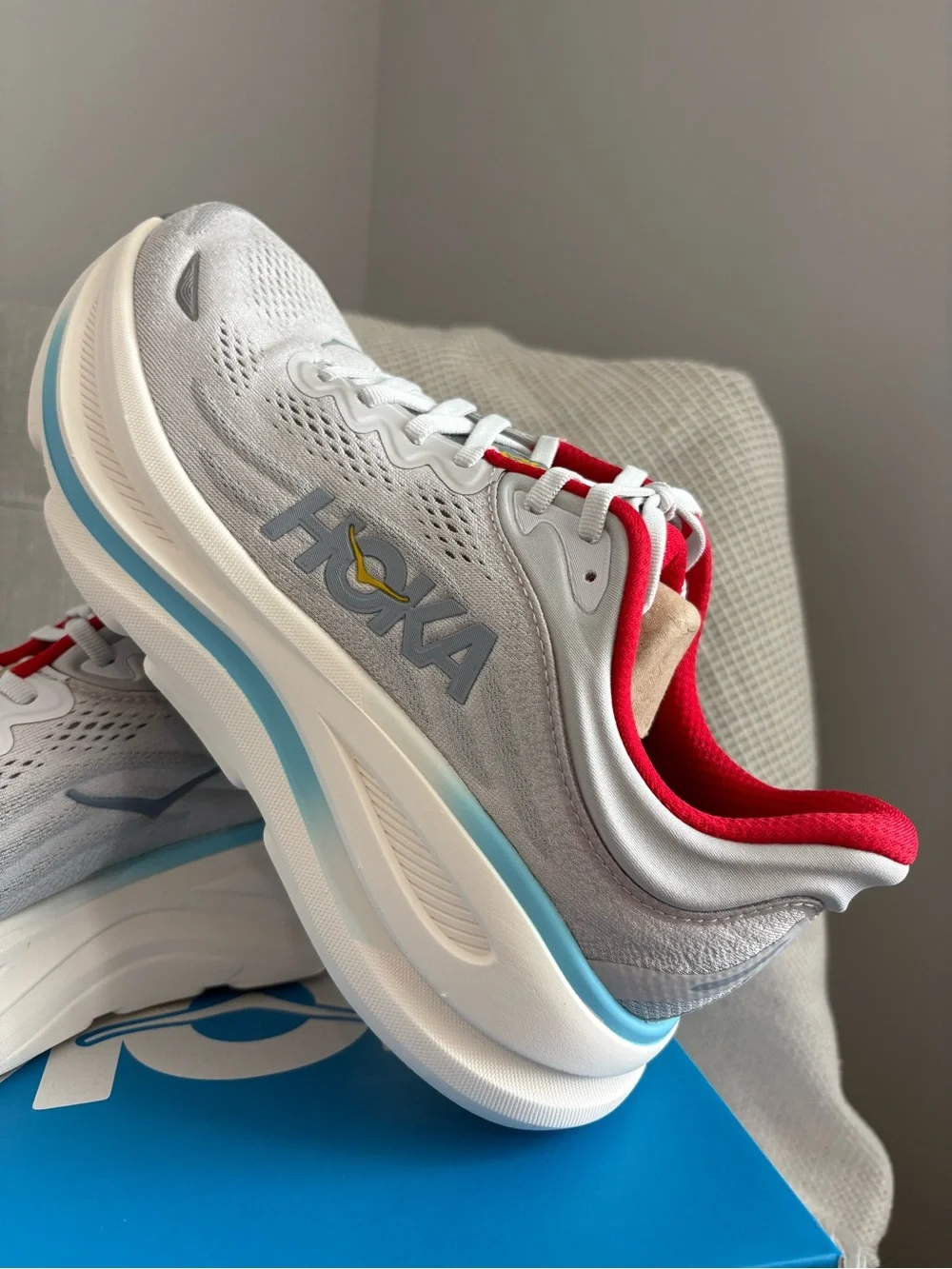 Hoka Women's Bondi 9 Light Gray Running Shoes with Red and Light Blue Accents